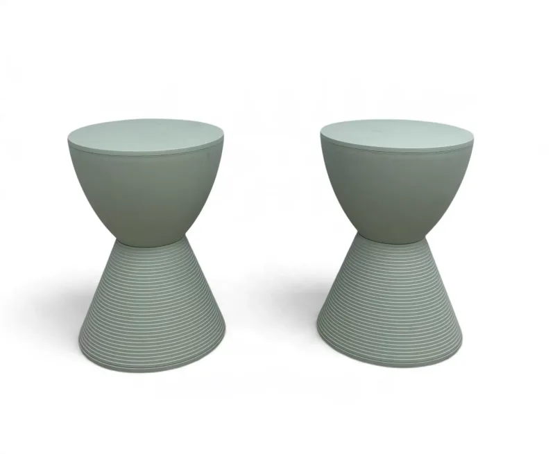 A pair of contemporary composite moulded mint green Prince AHA style stools each with a ribbed conical base after Philippe Starck for Kartell