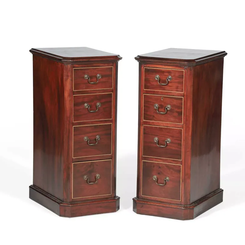 A Pair Of Mahogany Bedside Chests 20th Century, in the George III taste, each of narrow upright form with canted front angles