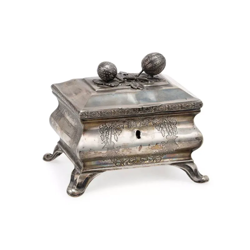 A Continental Silver Sugar Box 19th Century, of rectangular bombé form, with a domed hinged cover, the finial cast in the form of leaves and berries