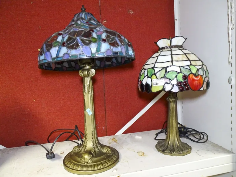 An Art Nouveau style lampbase with Tiffany style glass lampshade, and another (2)