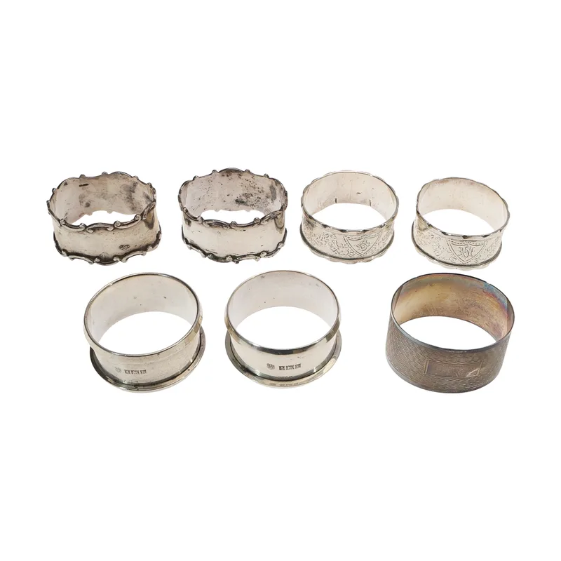 3 Silver and 4 White Metal Napkin Rings