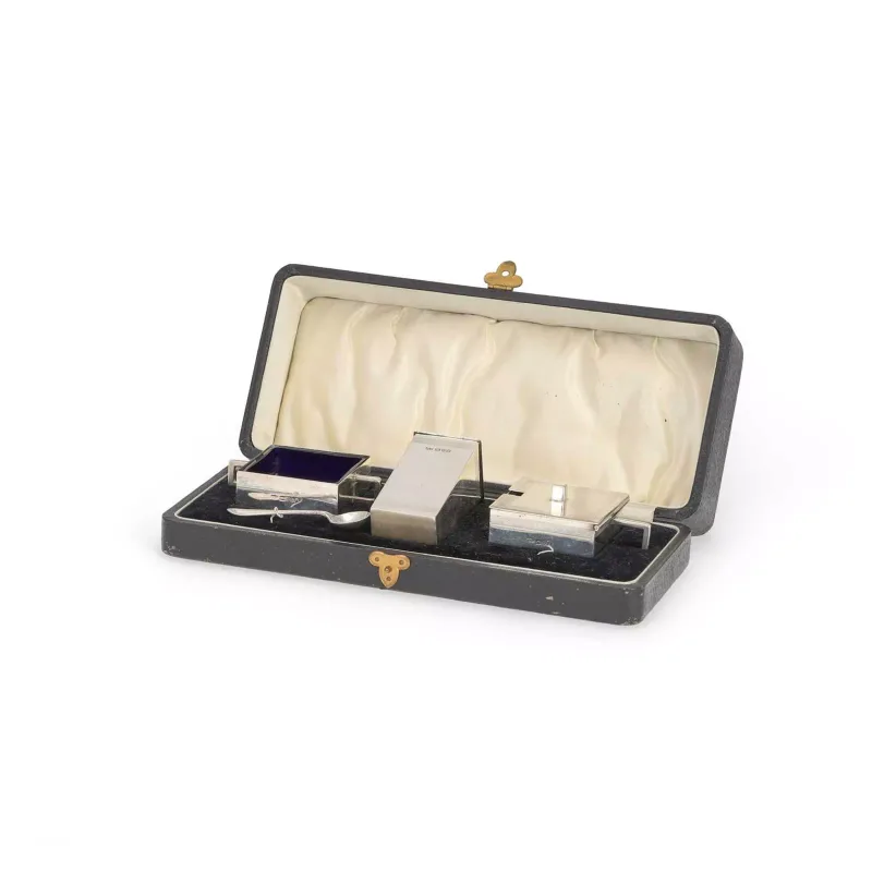 An Art Deco Silver Three-Piece Condiment Set by Jones & Crompton, Chester 1926, comprising an open salt with spoon, pepperette and a mustard pot