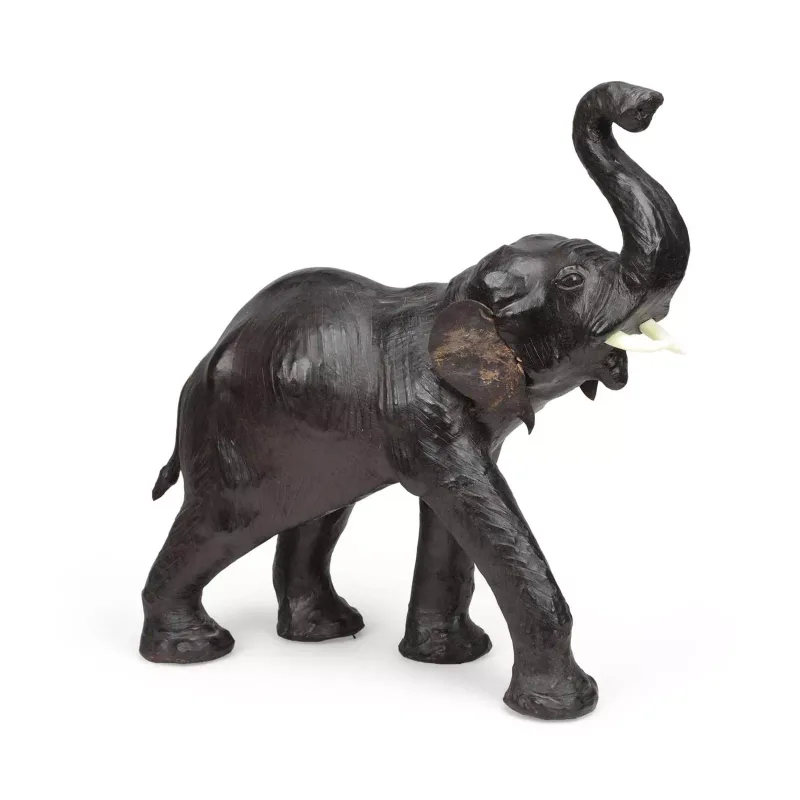 A Leather Model Of An Elephant of Liberty type, modelled walking with the trunk raised and the mouth open, with applied tusks.