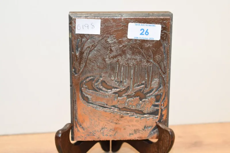 A vintage embossed relief copper panel depicting a horse-drawn cart travelling along a forest road, mounted upon a wooden block, unmarked,