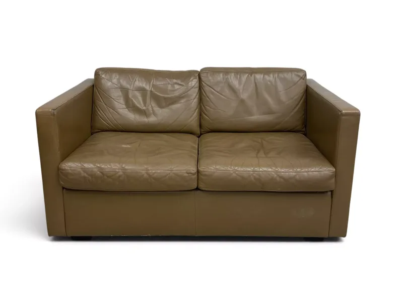 A vintage two seater sofa of compact size in leather upholstery. H