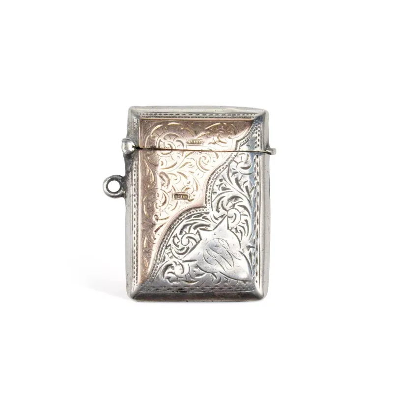An Edwardian Silver And Gold Vesta Case maker's marks worn, Birmingham 1902, of rectangular form with a hinged cover, foliate engraved