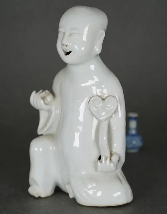 Kangxi (1662-1722) - Figurine - Seated Boy holding a Peach and Ruyi Scepter - Incense Burner (7 Smoke Holes on the Head, Back and - Porcelain