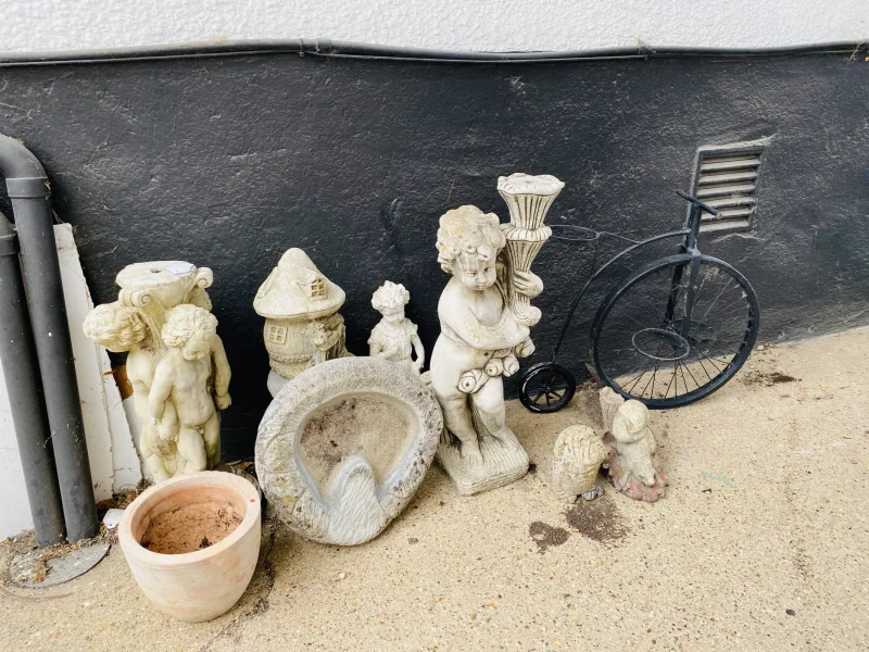 A collection of various decorative garden items to include statues, a penny farthing style pot holder, etc (qty)