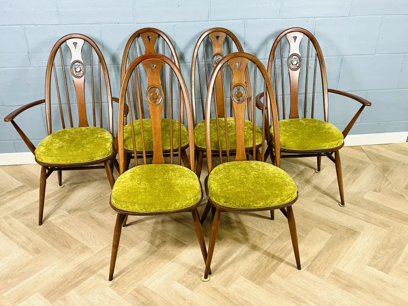 A set of six Ercol 'Swan back' dining chairs, to include four standard chairs and two elbow chairs