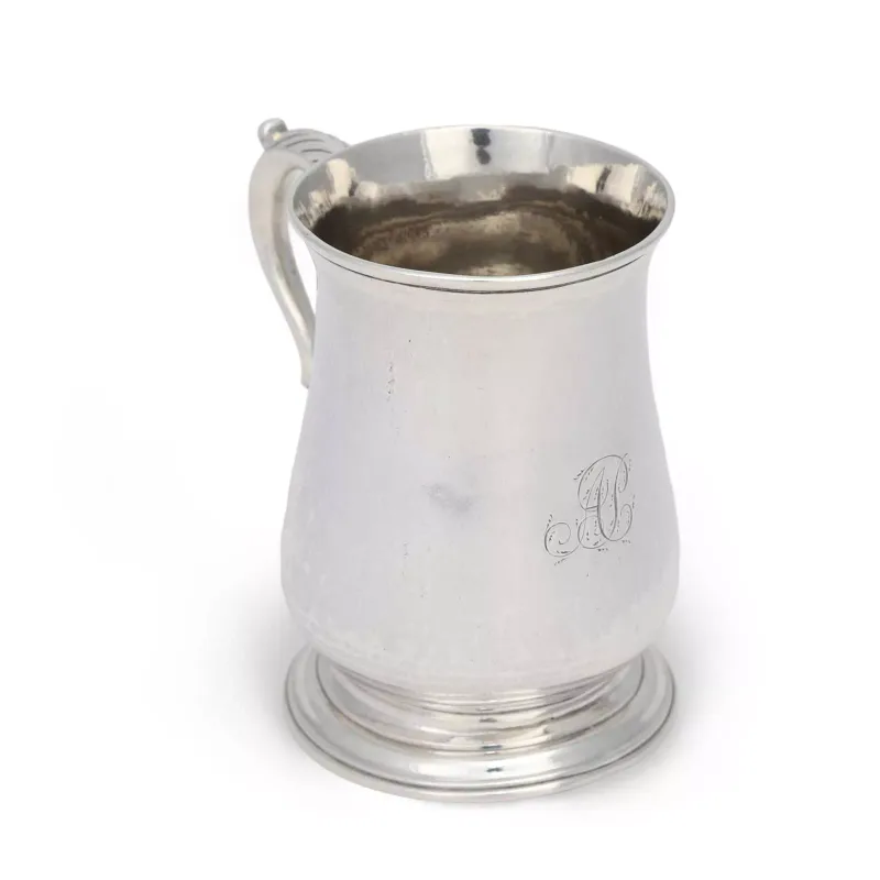 A George III Silver Half Pint Mug by I.W, London 1765, of baluster form with a moulded rim, the plain body engraved with a script monogram