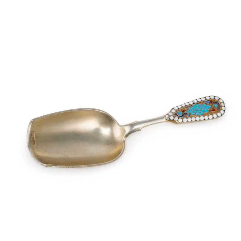 A Russian Silver-Gilt And Cloisonné Enamel Caddy Spoon late 19th Century, circa 1896, 84 Zolotnik marked, decorated with foliate cloisonné enamel in turquoise