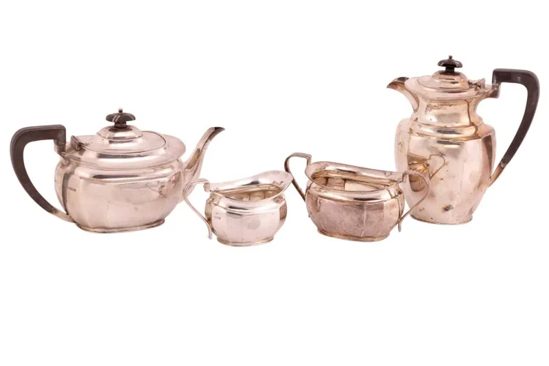 A four-piece silver tea service by Atkin Brothers, Shefflield 1935, comprising a teapot, a coffee pot, a twin-handled sugar bowl, and a creamer
