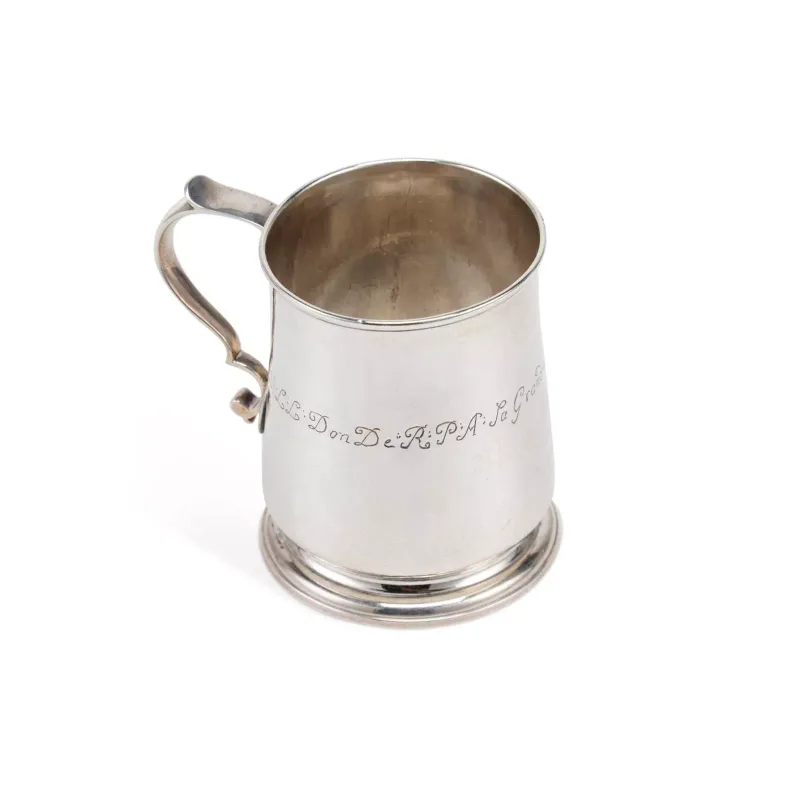 A George III Silver Mug maker's marks rubbed, London 1736, of typical form with a S-scroll handle on a spreading circular stepped foot