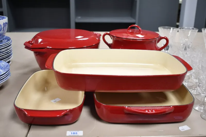 A selection of vintage AGA red enamel cookware, to feature three graduated oven dishes and two lidded cooking pots