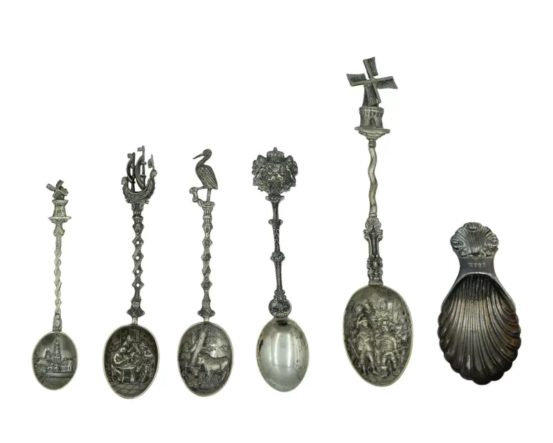 A selection of continental silver teaspoons and a caddy spoon