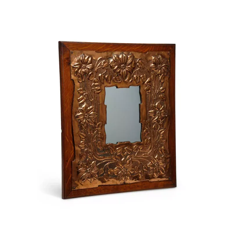 An Arts And Crafts Copper And Oak Wall Mirror in the manner of Keswick School of Industrial Arts