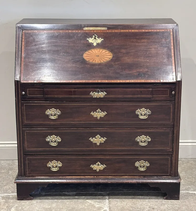 A George III mahogany and satinwood banded bureau, the rectangular top above a fall front with shell inlay, opening to reveal a compartmented interior