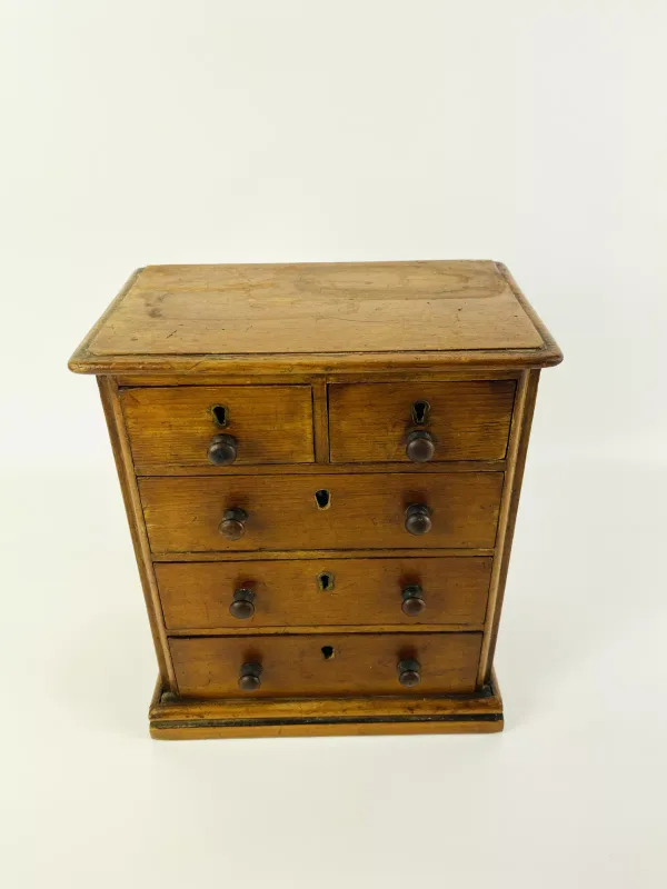 A 19th century pine miniature chest of drawers