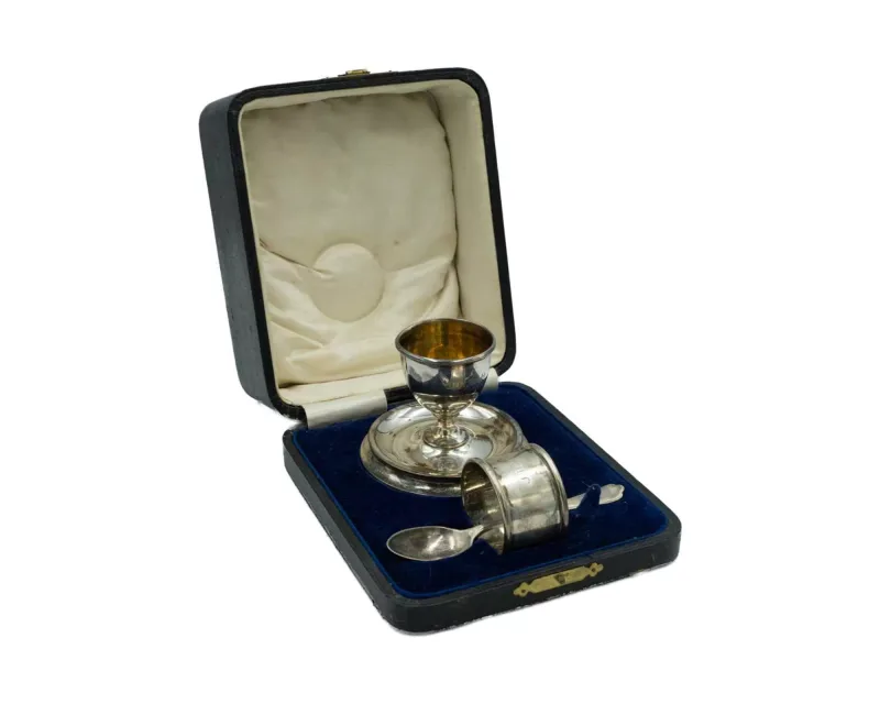 A cased George V silver egg cup and napkin ring Christening set by Levi & Salaman