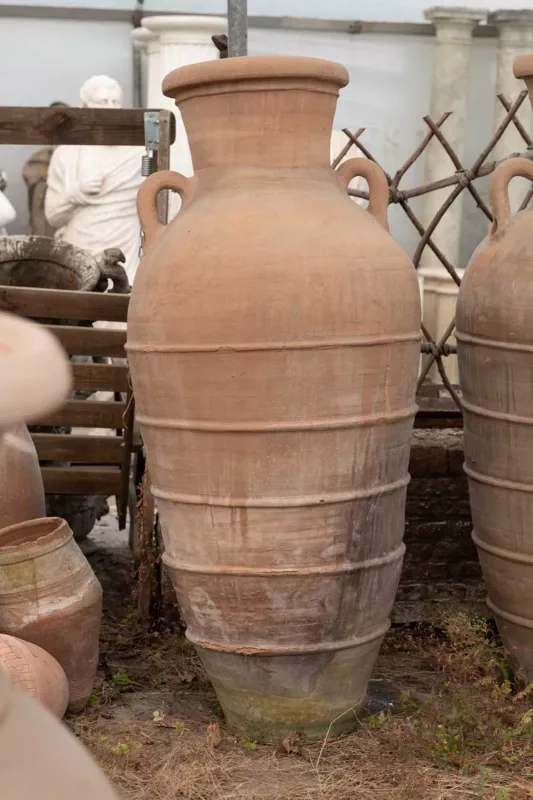 A large North African storage jar The jar of tall cylindrical form with lug handles and ring turned ornament Approximately