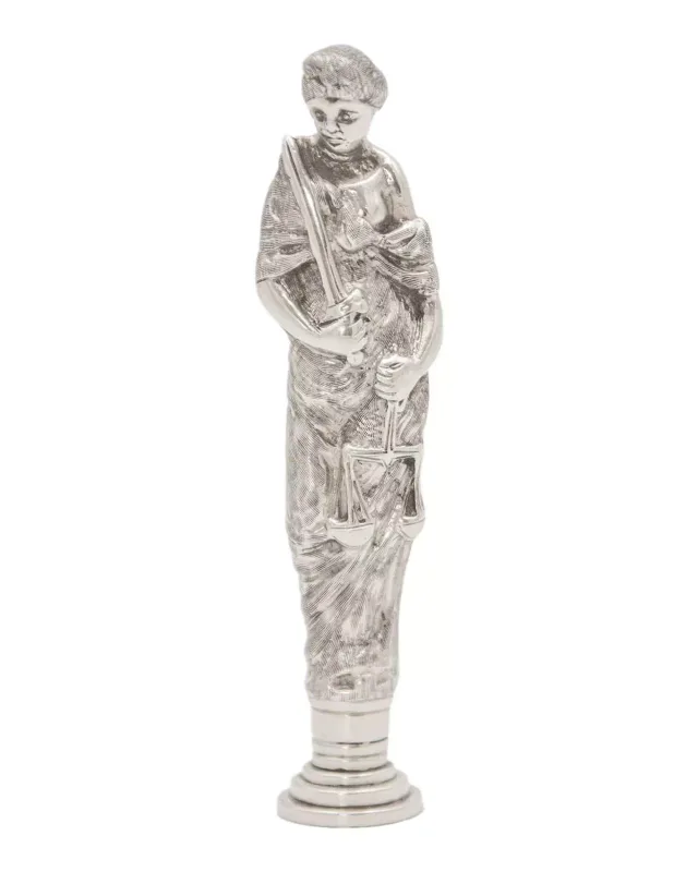 A heavy silver figural desk seal modeled as Justice