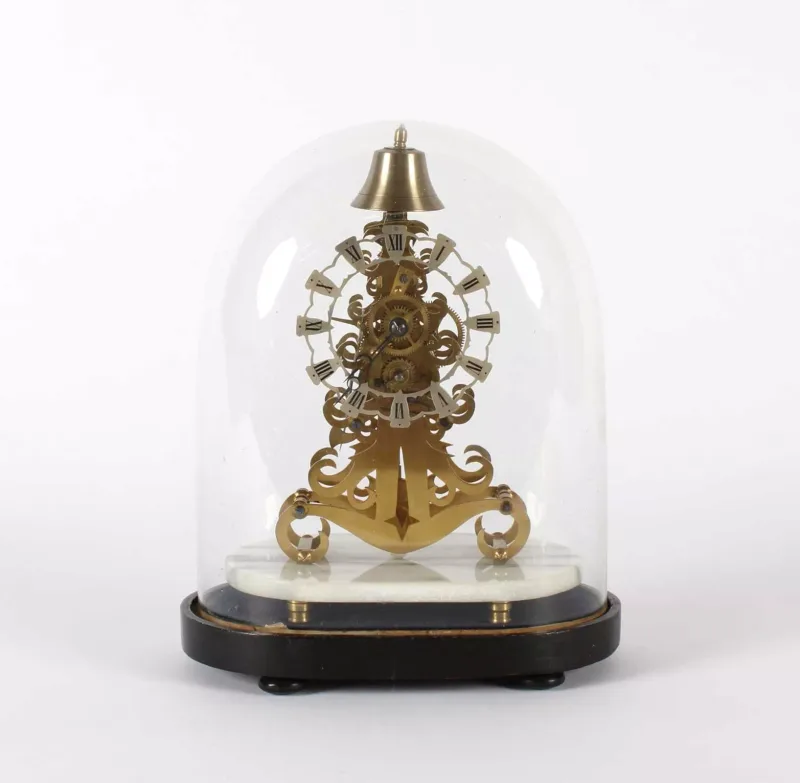A Small Brass Skeleton Mantel or Desk Clock A Small Brass Skeleton Mantel or Desk Clock , gilt and cast brass