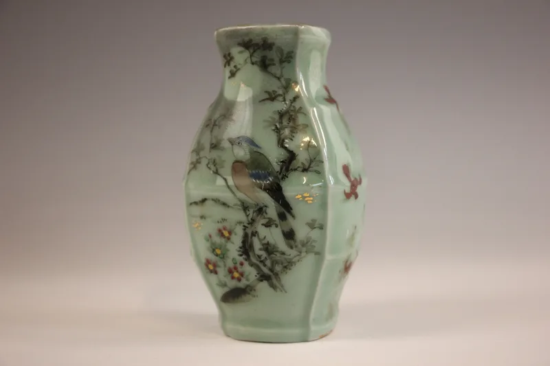 A celadon ground enamel painted posy vase, 20th century, painted to one side with an exotic bird perched in a tree