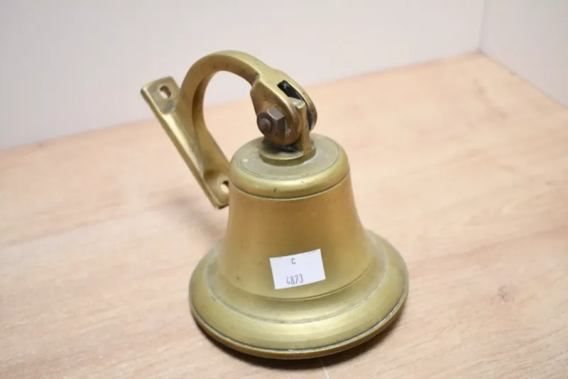 A small vintage brass ships type bell, having a wall bracket,