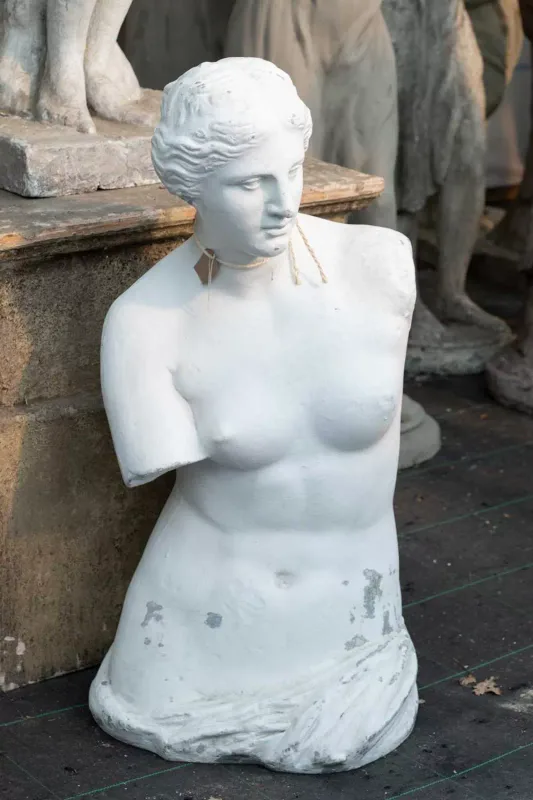 A sculpture reproduction depicting the Venus de Milo The composite sculpture with a white painted finish