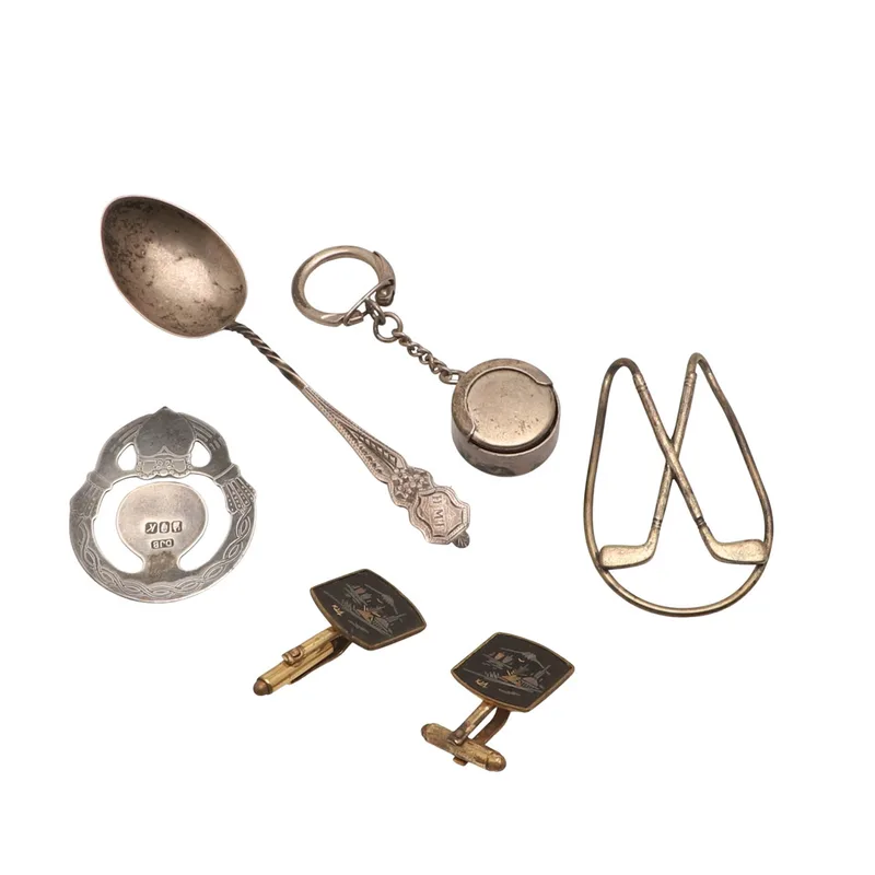 A Silver Money Clip, a Silver Keyring Coin Safe, a Silver Book Mark, Cufflinks and a Spoon