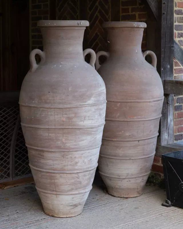 A pair of large North African storage vessels The jars with lug handles and ring turned decoration to the waisted bodies Approximately