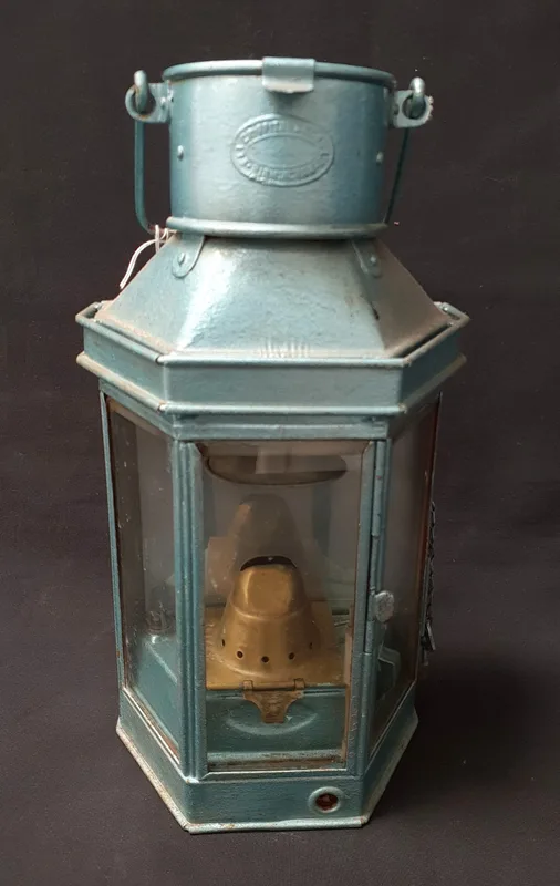 Hexagonal Railway Cabin Lantern made by Griffins & Sons, with a blue-green finish and turned wooden handle,